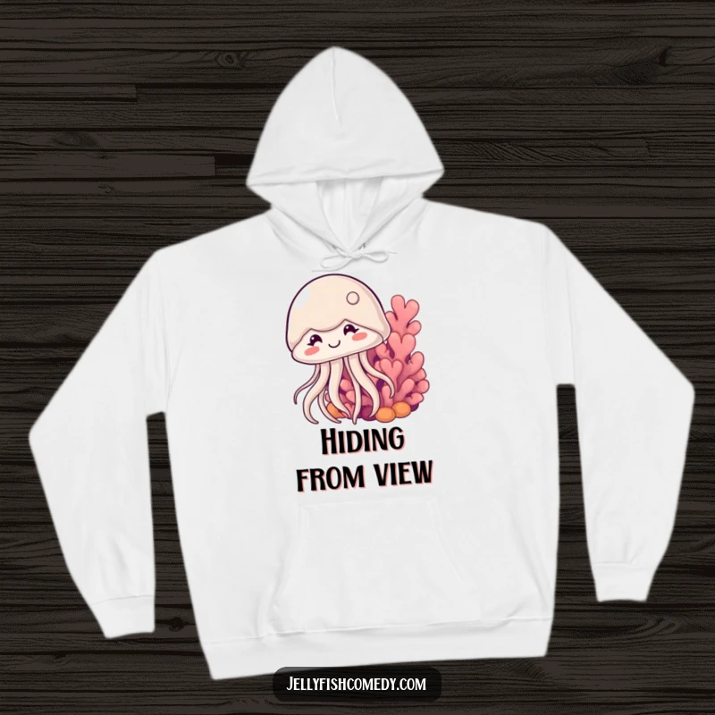 Funny shy jellyfish hoodie shows a cute, smiling jellyfish cautiously peeking from behind a coral, offering cozy ocean-themed fun.