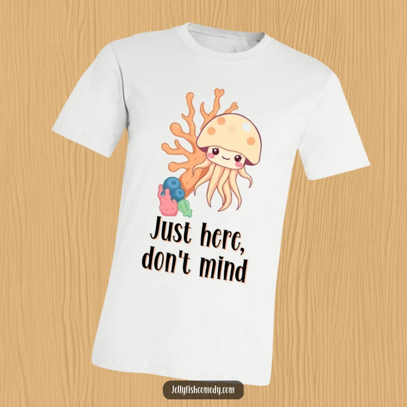 Funny kawaii jellyfish peeking from behind coral on a t-shirt, designed for humorous and aquatic-themed enjoyment.